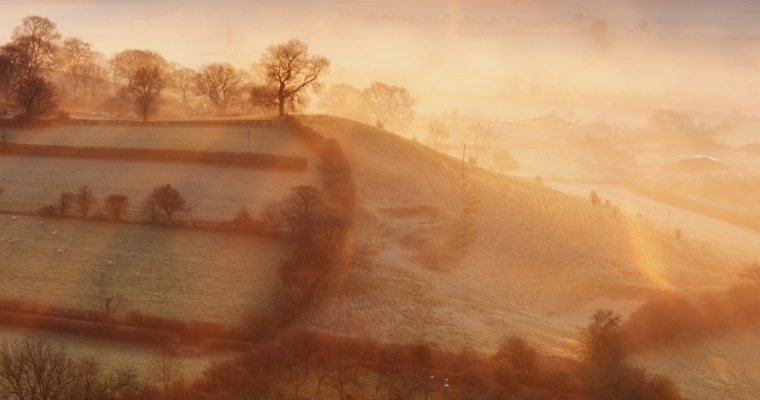 Misty Landscape of hills and fields